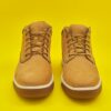 New mens leather brown waterproof hiking winter autumn boots on yellow background