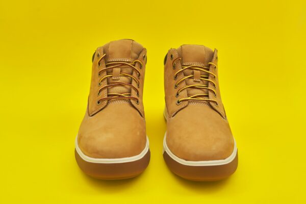 New mens leather brown waterproof hiking winter autumn boots on yellow background