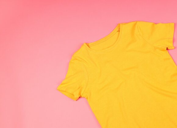 Yellow t-shirt with space for print on pink background
