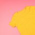 Yellow t-shirt with space for print on pink background