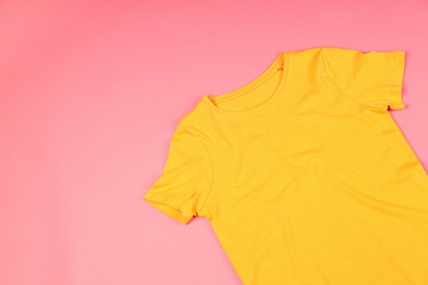 Yellow t-shirt with space for print on pink background